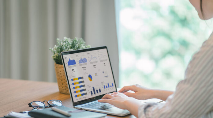 Businesswoman accountant using a calculator and computer