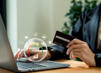 Businesswoman using laptop with credit score for student loan, mortgage and payment cards.