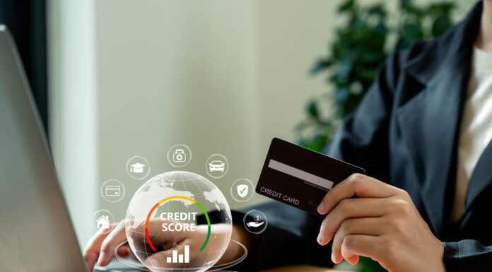 Businesswoman using laptop with credit score for student loan, mortgage and payment cards.