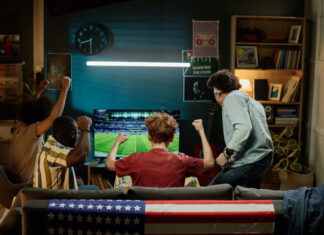 Happy Fans Watching Soccer Match on television