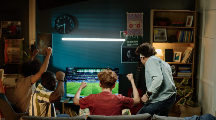 Happy Fans Watching Soccer Match on television