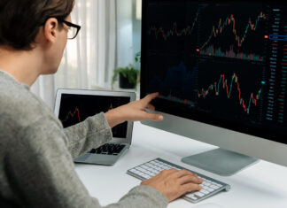 Crypto for Beginners: The Global Debt Crisis: Understanding the Risks and Challenges Investors pointing interesting stock exchange on pc with laptop