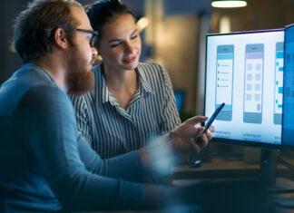 Handsome Male and Beautiful Female Mobile Application Designers Test and Discuss New App Features