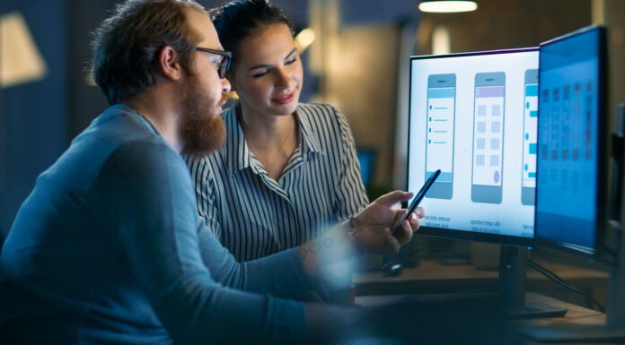 Flutter vs React Native: Which Framework Leads Mobile Development in 2025? Handsome Male and Beautiful Female Mobile Application Designers Test and Discuss New App Features