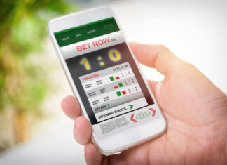 Man holding smart phone with working online betting mobile application