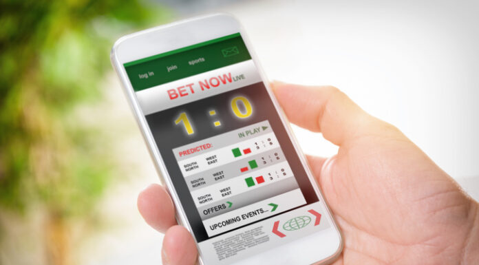 Man holding smart phone with working online betting mobile application
