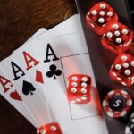 Red dice, cards and chips on computer