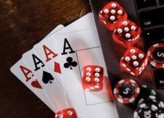 Red dice, cards and chips on computer