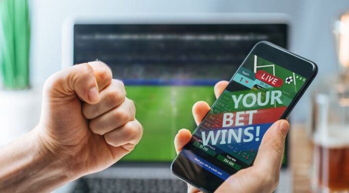 How Competition Breeds Innovation in the iGaming Industry Lucky man celebrating victory after making bets using gambling mobile application on his phone.