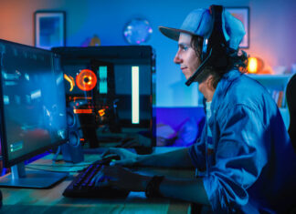Professional Gamer Playing First-Person Shooter Online Video Game on His Powerful Personal Computer