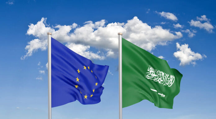 Thick colored silky flags of European Union and Saudi Arabia