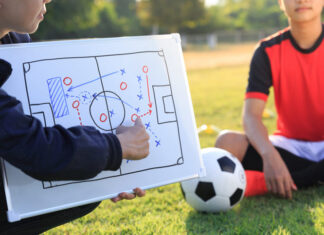 Coach training a tactic for football player