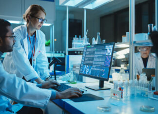5 Benefits Of Partnering With Clinical Trials Software Companies Female Research Scientist with Bioengineer Working on a Personal Computer with Screen Showing Gene Analysis Software User Interface.