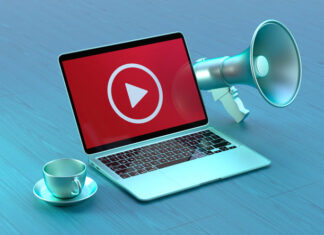 YouTube Business Strategy: Tips for Promoting Your Brand Online Laptop With a Playing Icon on the Laptop Screen