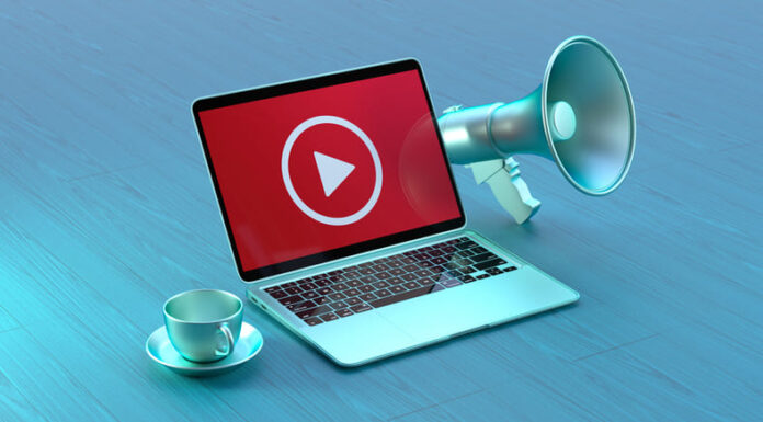 YouTube Business Strategy: Tips for Promoting Your Brand Online Laptop With a Playing Icon on the Laptop Screen