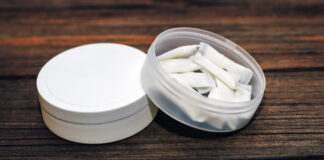 Nicotine Pouches: Innovative Solutions for Healthier Lifestyles in the Business World Snus box with nicotine pouches on wooden background