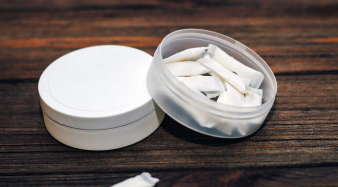 Nicotine Pouches: Innovative Solutions for Healthier Lifestyles in the Business World Snus box with nicotine pouches on wooden background