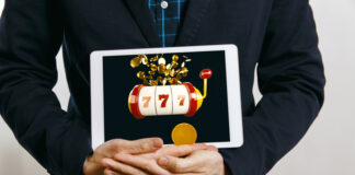 How Canadian Online Slots Are Redefining Entertainment for Players Across Borders man in suit holding tablet with casino slot with jack pot on screen