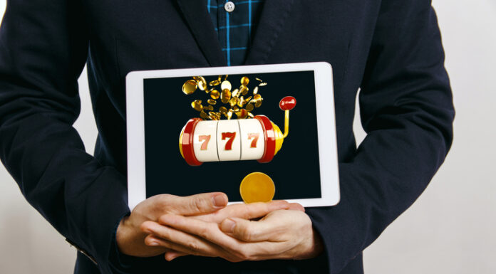 How Canadian Online Slots Are Redefining Entertainment for Players Across Borders man in suit holding tablet with casino slot with jack pot on screen