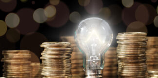 Financial Literacy: A Guide for Young People Lightbulb and stack of coins