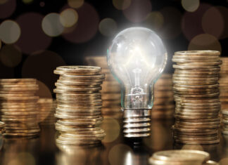 Lightbulb and stack of coins