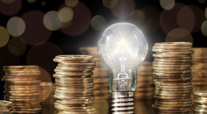 Financial Literacy: A Guide for Young People Lightbulb and stack of coins