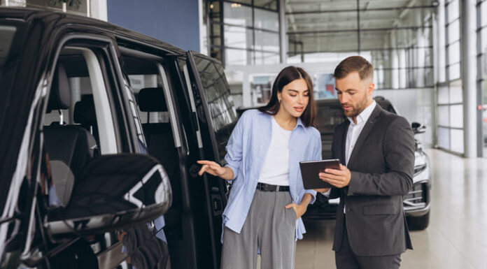 Lady Buyer Standing In Luxury Automobile Dealership Store.