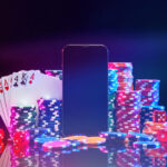 Brightly colored poker chips and playing cards arranged near a smartphone