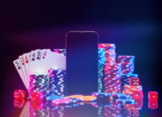 Brightly colored poker chips and playing cards arranged near a smartphone