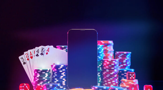 Brightly colored poker chips and playing cards arranged near a smartphone