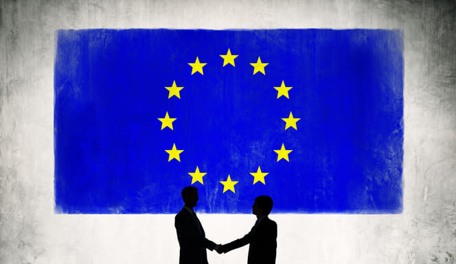 Business in Europe with the New Trump Administration Two Business Person Shaking Hands with the European Union Flag