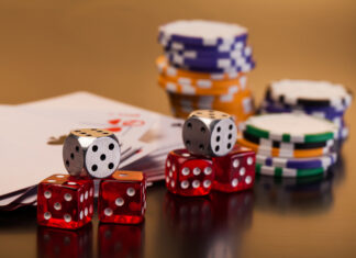 set of playing card with dices on reflective table