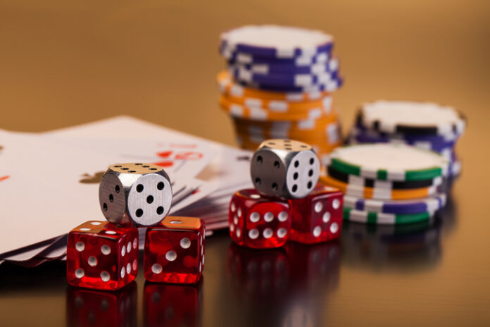set of playing card with dices on reflective table