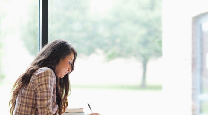 Tips for Balancing Work and Play for Academic Success Gorgeous student studying in the library
