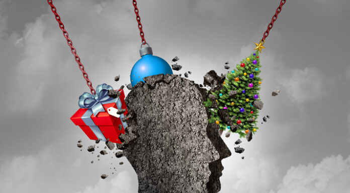 The Psychology of Christmas human head shape made of concrete being pounded by christmas symbols