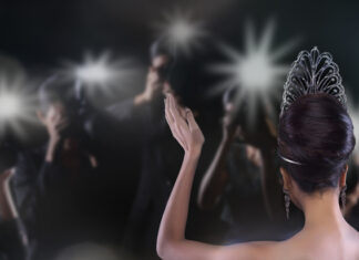 Powerful Pageants: What Smart Women can Learn from the Beauty Pageant Back side view of Miss Pageant beauty contest with Silver Diamond Crown wave hand to many Photographers