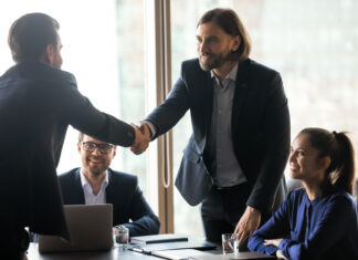 The Truth About Interim Consultants: High-Impact, Cost-Efficient, and Ready to Enrich Your Business Smiling businessmen handshake closing successful deal at meeting