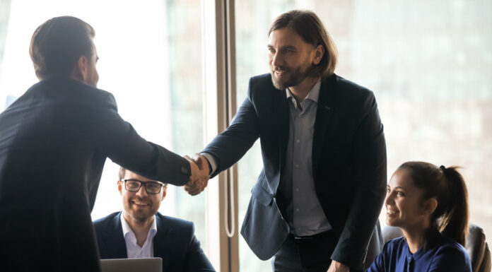 The Truth About Interim Consultants: High-Impact, Cost-Efficient, and Ready to Enrich Your Business Smiling businessmen handshake closing successful deal at meeting