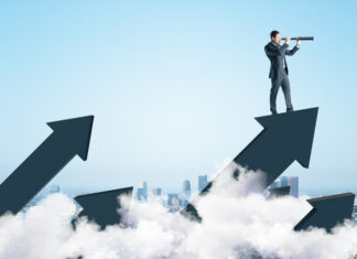 Why Forecasters are Fixated with Accuracy — The Risk of Ignoring Feedback Businessman standing on abstract arrow and using telescope to look into the distance on city background.