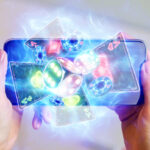 in a man's hand a smartphone with playing cards neon, roulette and chips, neon background