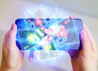 in a man's hand a smartphone with playing cards neon, roulette and chips, neon background
