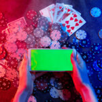 Playing cards, betting Chips and a smartphone with a copy space in women's hands