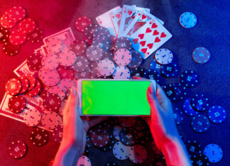 Playing cards, betting Chips and a smartphone with a copy space in women's hands