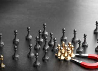 5 Transformative Changes to Help Companies Retain Talent in 2025 Horseshoe magnet attracting golden pawns over black