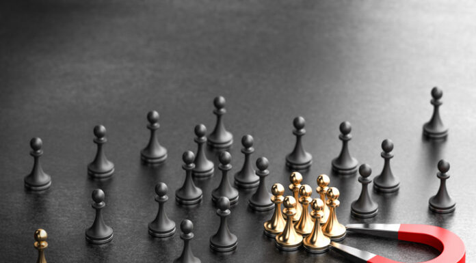 5 Transformative Changes to Help Companies Retain Talent in 2025 Horseshoe magnet attracting golden pawns over black