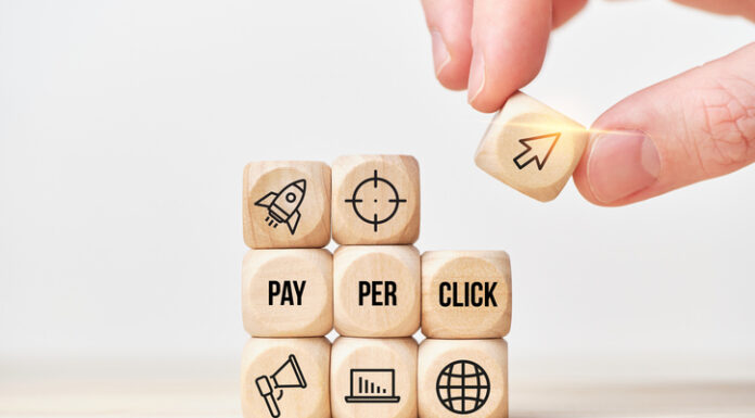 Person stacks wooden cubes from text and icons
