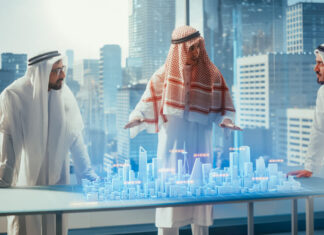Saudi Arabia Charts Ethical AI Future with Ambitious Framework Business Developers in Traditional Clothes Discuss Investing Opportunities Based on Holographic Augmented Reality 3D City Model in Their Modern Office in a Skyscraper.