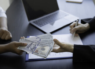 Person handing dollars to someone