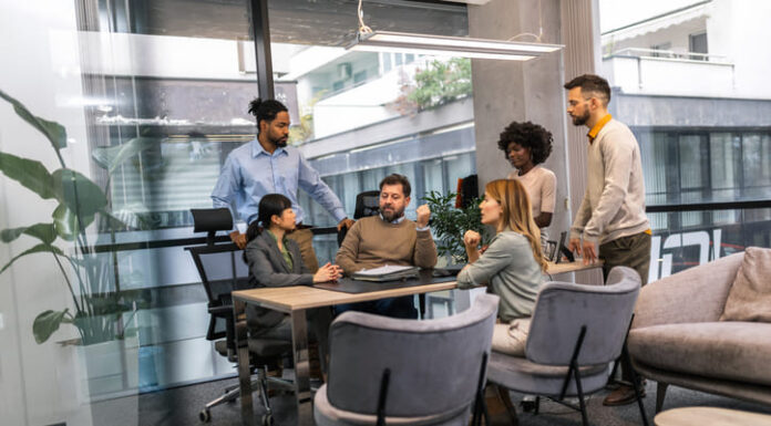 International workers group and team leader having teamwork discussion managing project at work in meeting room.