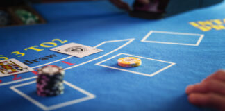 Live Blackjack: Everything You Need to Know Before Playing Anonymous Croupier Dealing Playing Cards on a Blackjack Table with Bet Chips in Place.